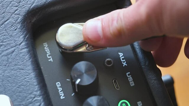 Man plug in jack on guitar amplifier. 4k video footage UHD 3840x2160
