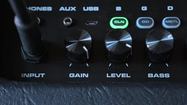 Man tunung knobs on guitar amp. 4k video footage UHD 3840x2160