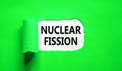 Nuclear fission symbol. Concept words Nuclear fission on beautiful white paper. Beautiful green paper background. Business science nuclear fission concept. Copy space.