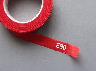 Red tape with text written Ego - idea or opinion that one have of yourself, level of one's ability...