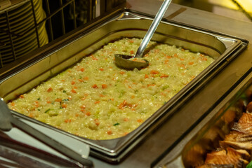 a bowl filled with stewed vegetables at a buffet