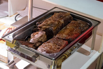 meat in a bowl at a buffet