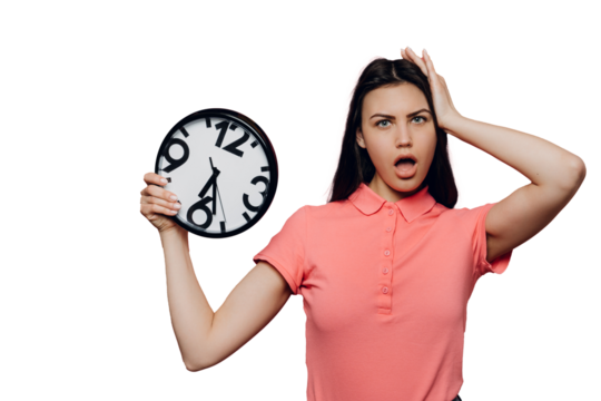 Shocked young brunette woman girl in pink t-shirt posing isolated on transparent background. People sincere emotions lifestyle concept. Mock up copy space. Holding clock, putting hand on head.