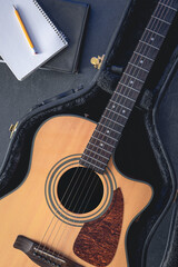 Fototapeta premium Acoustic guitar and notepad with pencil, top view.