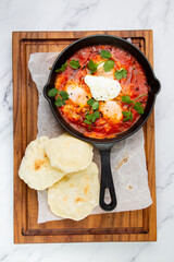 beetroot borscht with sour cream and parsley in a frying pan, side view