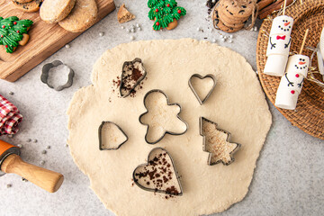 Raw dough for baking traditional Christmas sugar cookies, and cookie cutters.