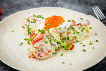 salad with mozzarella, caviar and green onions on a white plate, side view