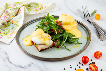 breakfast of arugula and tomato, toast with cheese and poached egg, top view