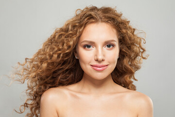 Naklejka premium Attractive good-looking young woman with natural clean healthy skin and long wavy hairstyle fashion beauty portrait