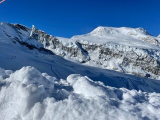 snowy mountain tops against dark blue ski from piz allalin saas fee valails wallis switzerland december 2023