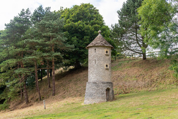 Fototapeta na wymiar View of a brick bird tower or wildlife tower that provides a nesting place for swallows and barn owls near Horton, Bristol, UK along the public footpath of Cotswold Way