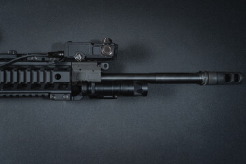 Firearms.  AR 15 rifle barrel with mounted laser sight and tactical flashlight.