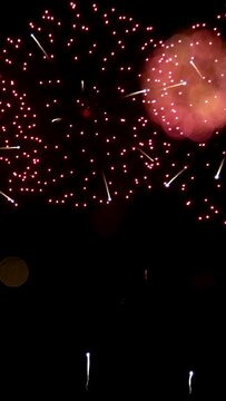 4K vertical. seamless looping of real beautiful fireworks background during new year's eve countdown celebration, real golden shining firework festival in the sky at night with colorful.