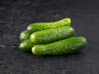 Fresh green cucumbers on grey background