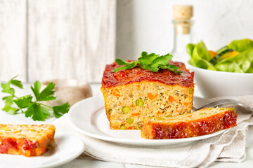 Meatloaf or terrine with chicken and turkey meat, carrot,  leek and green peas, glazed with...