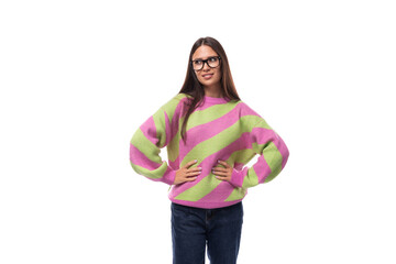 well-groomed pleasant smiling young european brunette woman dressed in a casual striped pink-green pullover