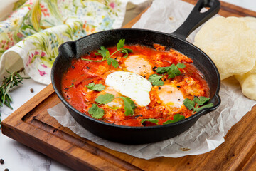 beetroot borscht with sour cream and parsley in a frying pan, side view