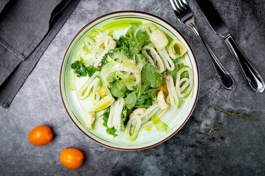 salad with arugula, parsley, lime and squid rings, side view