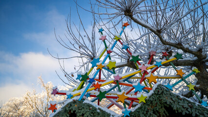 Christmas Market Stand Adorned with Colorful Stars and Decorative Beams