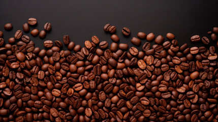 Roasted coffee beans on a wooden dark table, top view. Background of fragrant brown coffee beans scattered over the surface. copy space. Place for text.