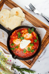 beetroot borscht with sour cream and parsley in a frying pan, side view
