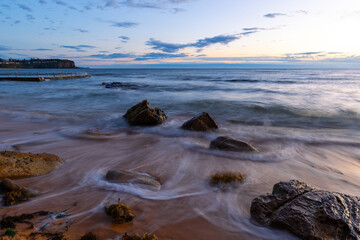 Cloudy morning view over rocky beach shore.