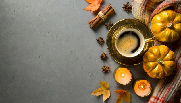 set the autumn mood with this top view photo of gilded cup of coffee with spices patchy scarf with pumpkin candles on grey backdrop make it a perfect composition for text or advert placement