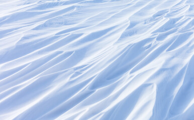 Natural winter texture of snowy sastrugus white crust on frozen Baikal Lake in cold February day....