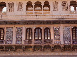 A section of windows, balconies and stone jalis incorporated in the City Palace at Udaipur, India