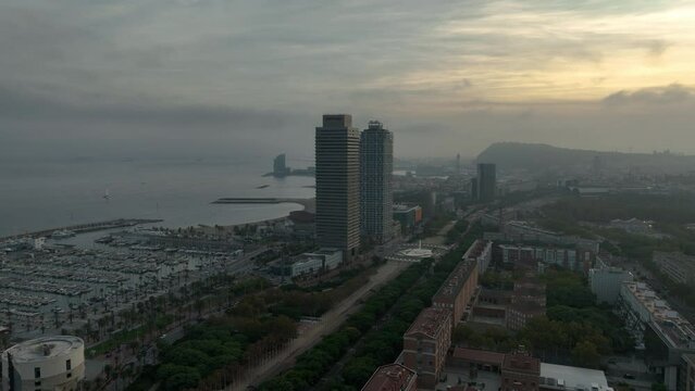 sunset time barcelona city center traffic street road fountain circle beach bay aerial panorama 4k spain