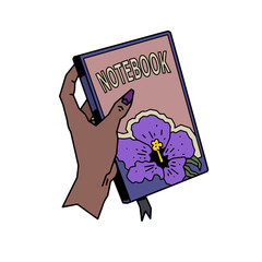 hand holding a book with picture of flower stcker notebook of goals