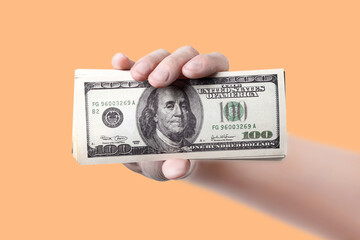 hand shows the money close up orange background