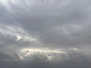 Naklejka na ściany i meble Blue and grey clouds in the overcast sky