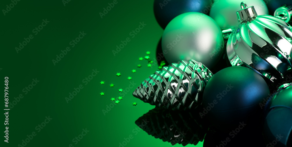 Wall mural Christmas and New Year green color baubles decoration background.  Art design backdrop with holiday ball. Beautiful Christmas balls closeup. Copy space