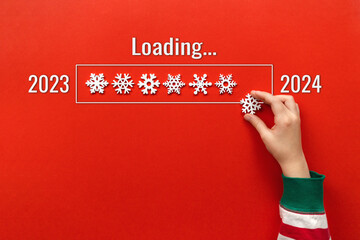 loading New Year. hand puts snowflake on red background. holiday banner