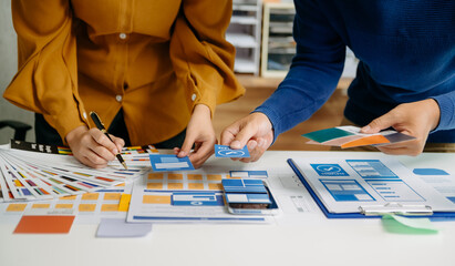 UX developer and ui designer brainstorming about mobile app interface wireframe design with...