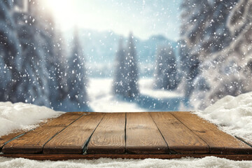 Wooden desk cover of snow flakes and blurred landscape of mountains. Cold december day. Empty space...