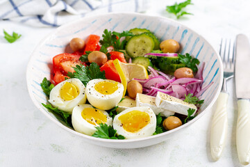 Breakfast. Greek salad and boiled eggs. Fresh vegetable salad with tomato, cucumbers, olives, arugula and cheese.