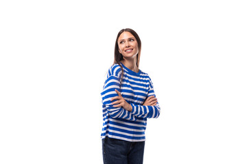 positive smiling young brunette woman in a striped blue blouse on a white background with copy space