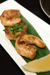 Spicy roasted shrimp in a white plate , black background,