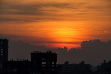 Beautiful orange sky during sunset over buildings at Pune India.
