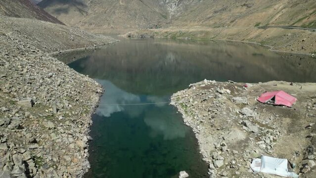Aerial low flypast shot of Lulusar Lake near Babusar pass. Lulusar, or Lalusar, is a group of mountain peaks and a lake in the Kaghan Valley in the Khyber-Pakhtunkhwa province of Pakistan.