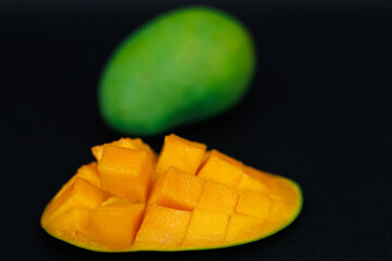 mango harumanis slice isolated on black. selective focus. shallow depth of field.