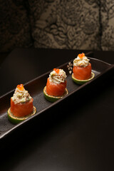 Sushi rolls with salmon, lime, red caviar, close-up