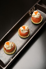 Sushi rolls with salmon, lime, red caviar, close-up