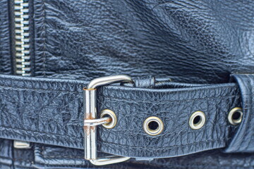 black leather fastened fashion belt with iron shiny buckle and iron zipper on biker stylish leather...