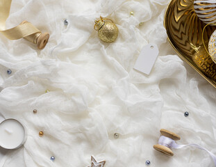 Christmas celebration concept composition with golden and white decoration on the table. Close up. Copy space	