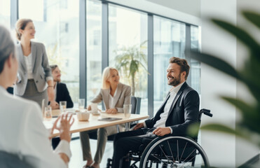 Businessman in wheelchair having business meeting with team at office. A group of young freelancers agree on new online business projects. Person in a wheelchair leading a meeting in a conference room