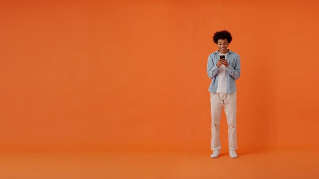 Cheerful multicultural man pointing aside at copy space
