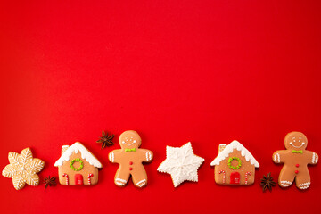 Tasty gingerbread cookies on red background. Copy space